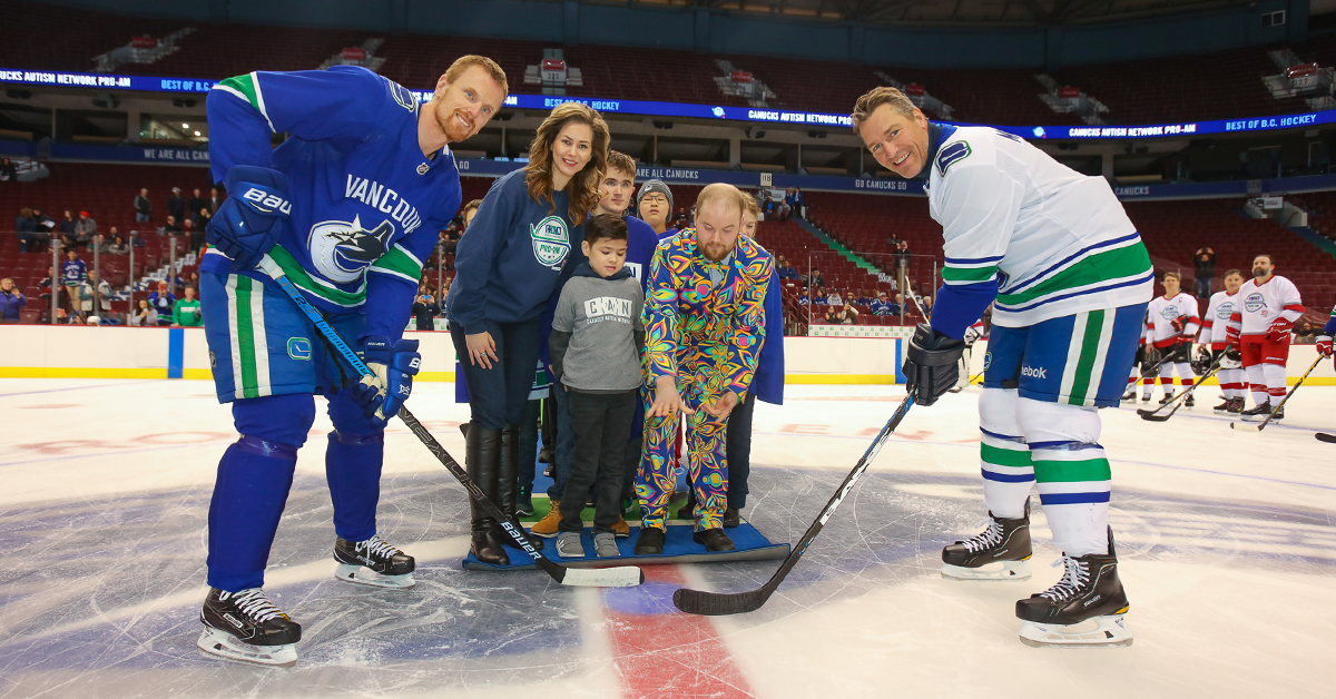 Vancouver Canucks Alumni Daniel Sedin and Kirk McLean with representatives from the Canucks Autism Network at a ceremonial puck drop at Rogers Arena